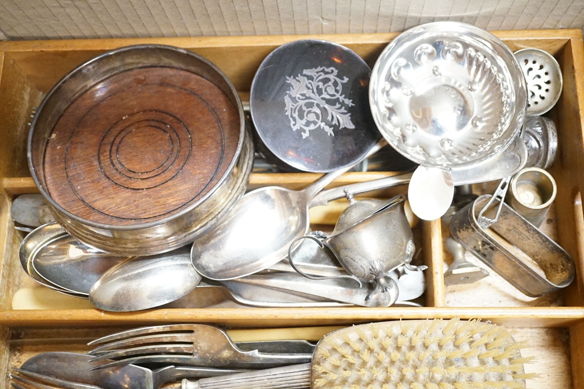Small silver cutlery, together with a silver presentation coaster, a silver backed brush and various plated wares